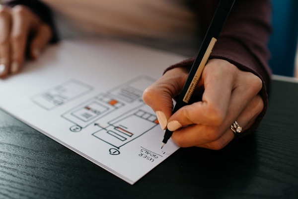 Designer mapping interface wireframes and user flows